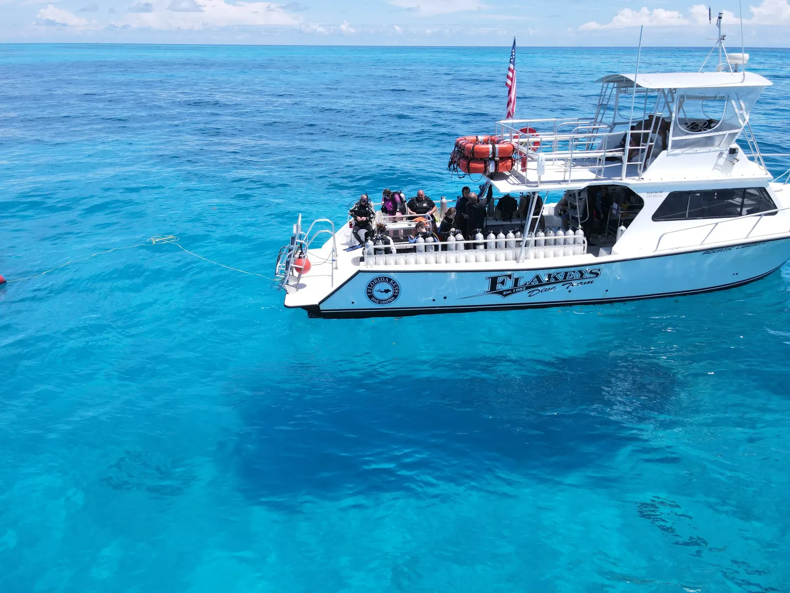 Dive boat moored over a shallow reef, seen from above