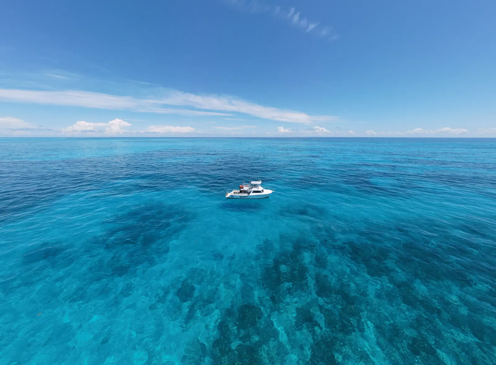 Aerial view of the Florida Keys Dive Center boat on crystal-clear turquoise water off Islamorada